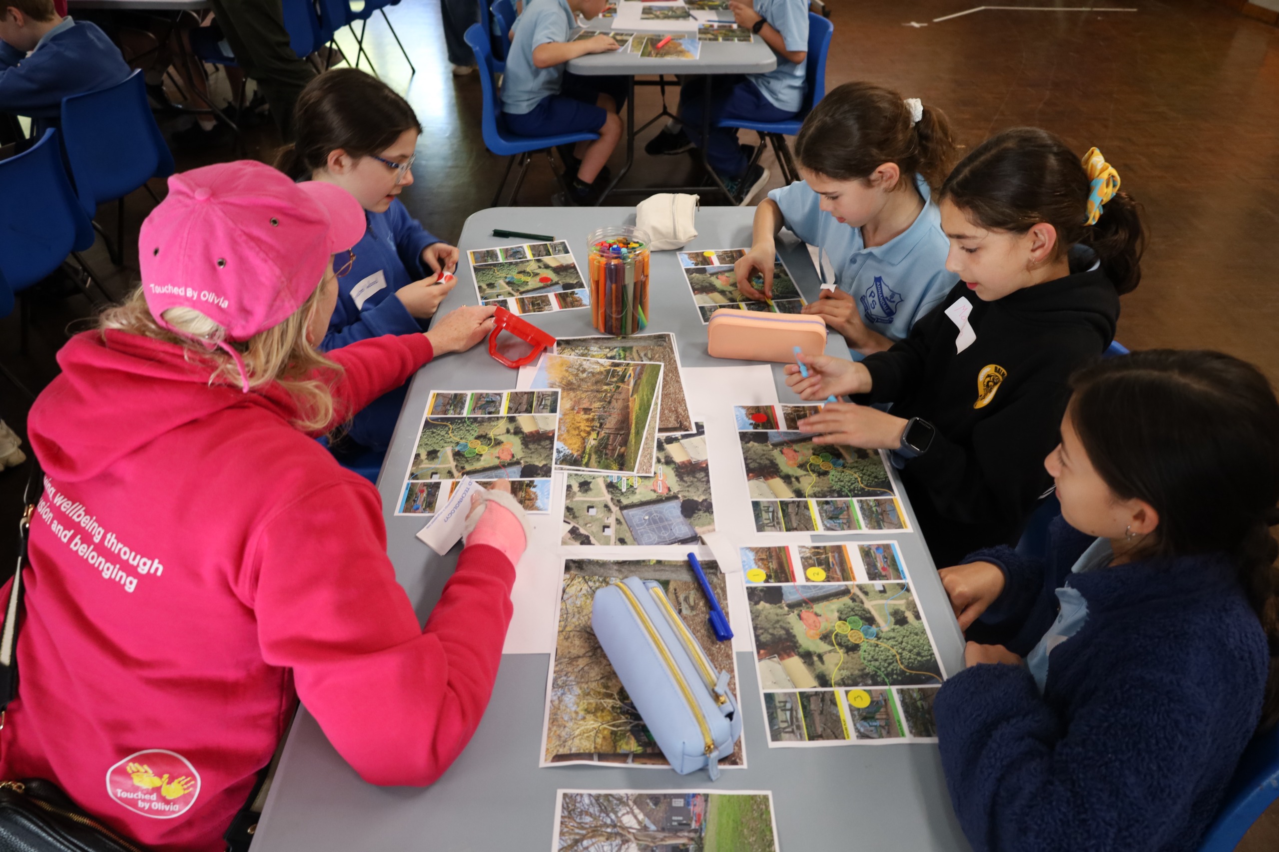 Touched by Olivia staff table facilitating with students