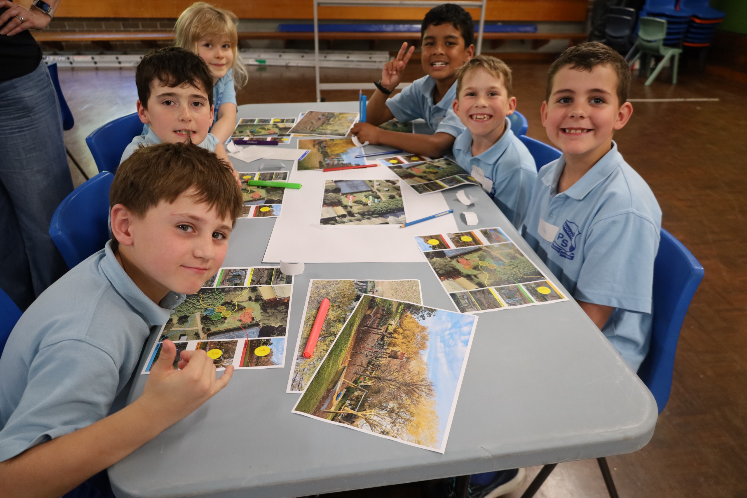 Students posing for the camera with their artworks.
