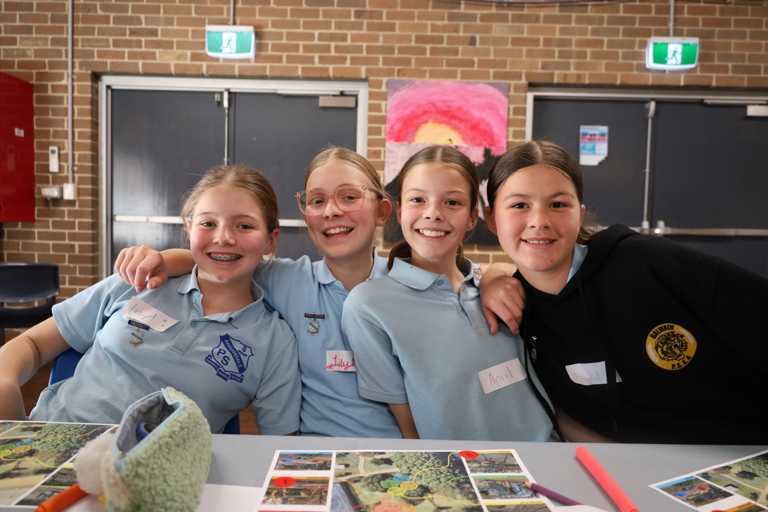 Students posing for the camera with their artworks.