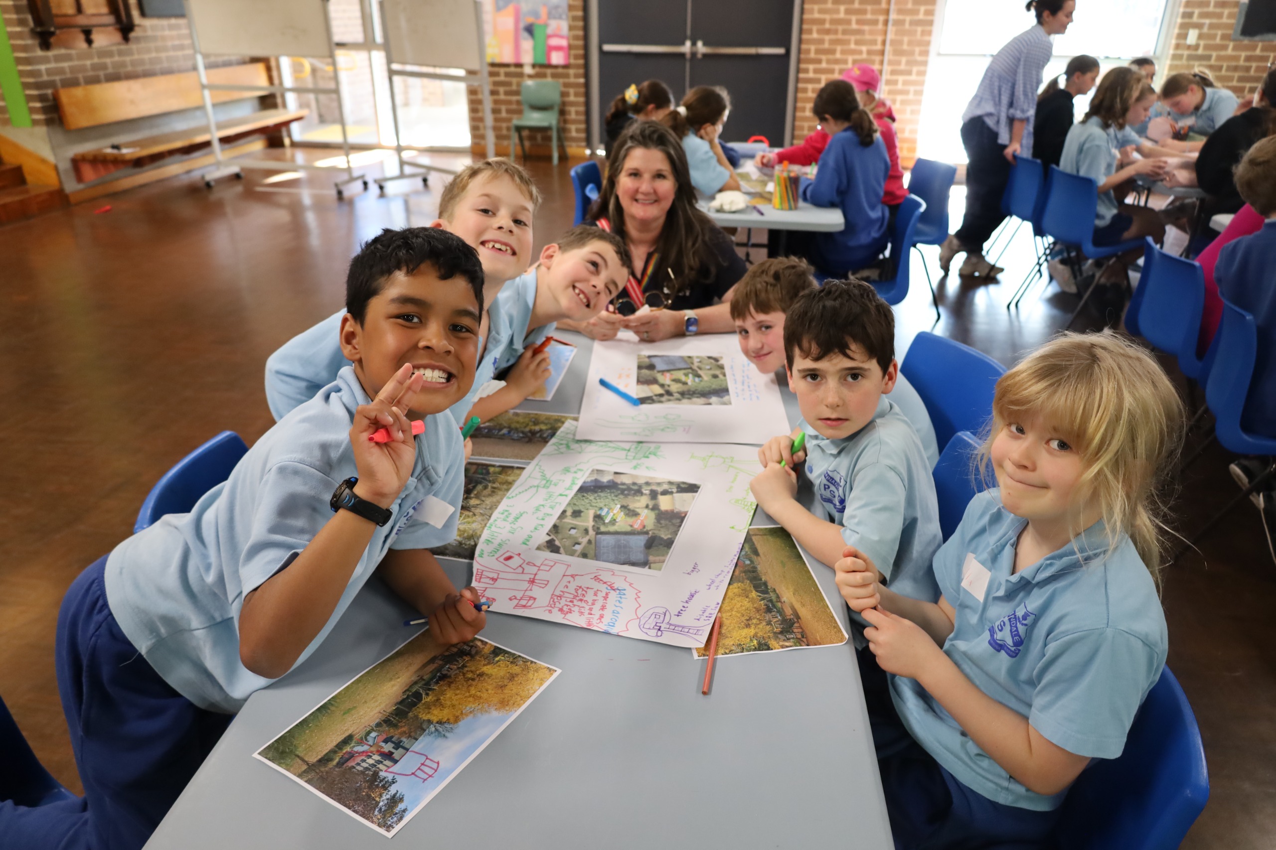 Students posing for the camera with their artworks.